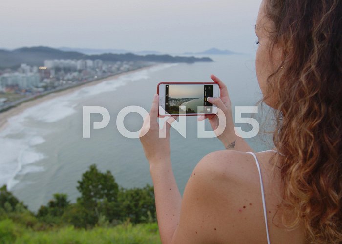 Careca Hill Brazilian girl taking pictures of sunset... | Stock Video | Pond5 photo