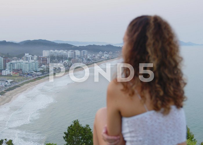 Careca Hill Cute girl admiring the sunset at careca ... | Stock Video | Pond5 photo